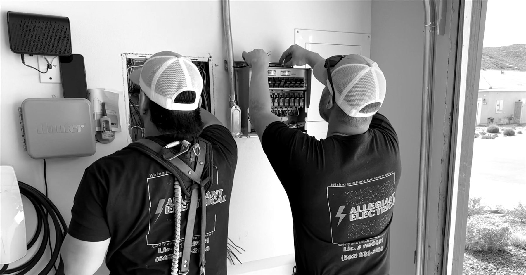 Allegiant team members working at an electrical panel
